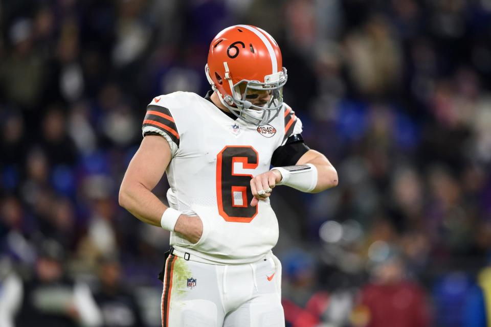 Cleveland Browns quarterback Baker Mayfield checks his plays on his wristband during the first half of an NFL football game against the Baltimore Ravens, Sunday, Nov. 28, 2021, in Baltimore. (AP Photo/Gail Burton)