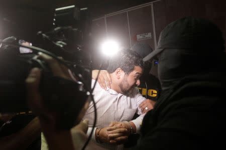 Roberto David Castillo, (C), executive president of Desarrollos Energeticos (DESA), is arrested by police officers on charges of helping plan the murder of indigenous environmental activist Berta Caceres two years ago, in Tegucigalpa, Honduras March 2, 2018. REUTERS/Jorge Cabrera