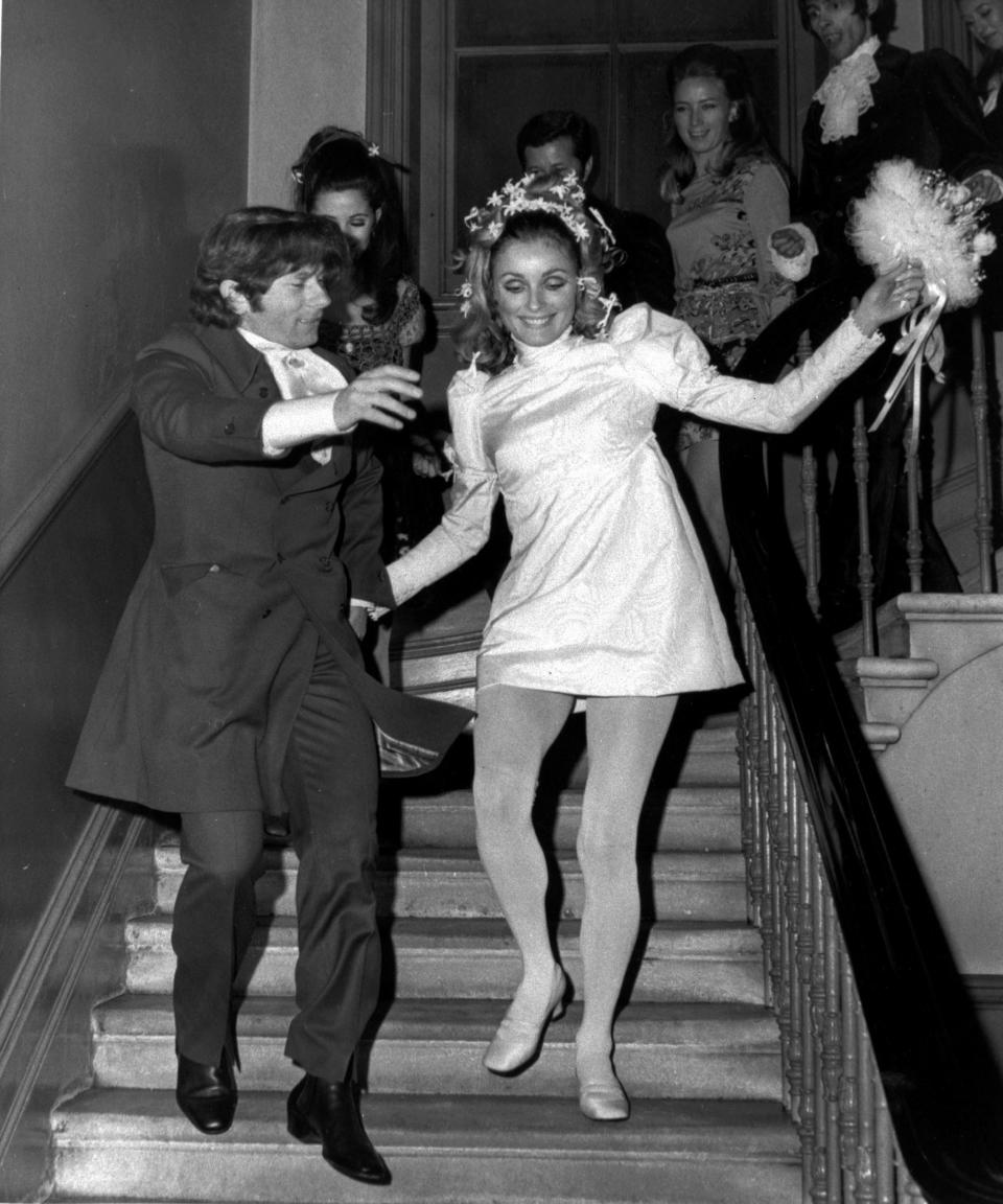 FILE - In this Jan. 20, 1968 file photo, American actress Sharon Tate and Polish born film director Roman Polanski skip downstairs after their wedding at Chelsea Register Office in London. Tate was a model and rising film star after her breakout role in the 1966 film, "Valley of the Dolls." She was 8-1/2 months pregnant when she was attacked as she pleaded with her Manson Family killers to spare the life of her unborn son as they killed five people at the home she and Polanski shared in the Bel-Air area of Los Angeles on Aug. 8-9, 1969. (AP Photo/Eddie Worth, File)