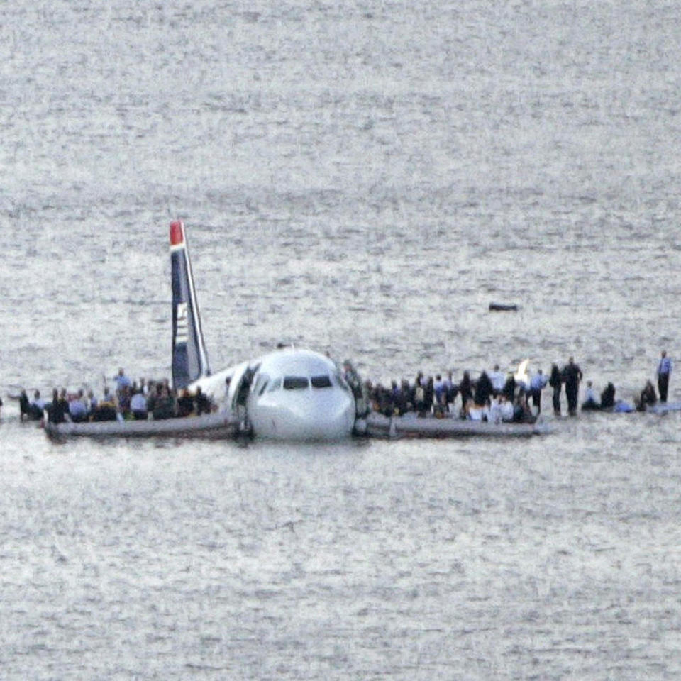 Image: Passengers stand on the wings of a U.S. Airways plane as a ferry pulls up to it after it landed in the Hudson River in New York (Gary Hershorn / Reuters)