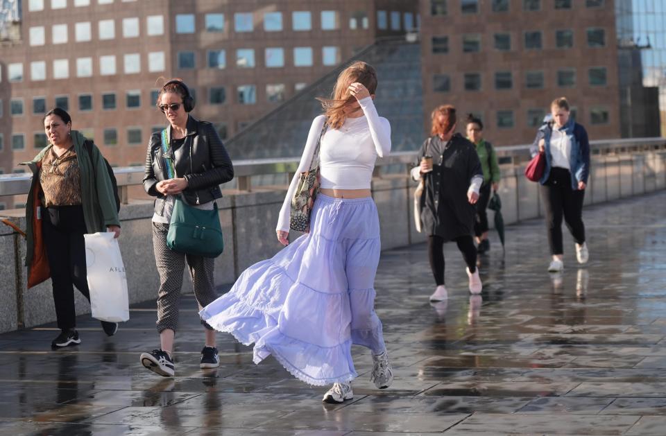 People walking in windy conditions on London Bridge as storm Lilian hits the UK (Yui Mok/PA Wire)