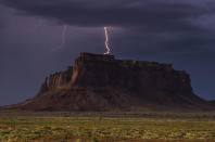 <p>Rain and lightning bolts hammer the desolate terrain of Monument Valley, Ariz. (Photo: Jennifer Khordi/Caters News) </p>