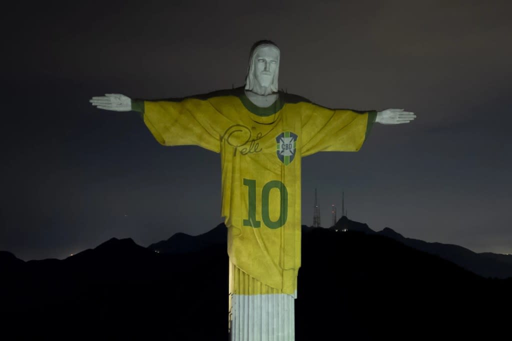 The Christ the Redeemer statue is illuminated with an image of Pele’s Brazilian jersey, as a tribute to the soccer legend on his one-year death anniversary, in Rio de Janeiro, Brazil, Friday, Dec. 29, 2023. (AP Photo/Bruna Prado)