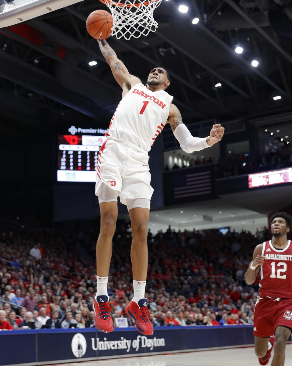 Dayton's Obi Toppin (1) dunks as Massachusetts' Carl Pierre (12) during the first half of an NCAA college basketball game, Saturday, Jan. 11, 2020, in Dayton. (AP Photo/John Minchillo)