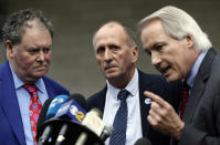 British cave explorer Vernon Unsworth, center, with his attorneys, Mark Stephens, left, and Lin Wood, take questions from the media outside U.S. District Court Friday, Dec. 6, 2019. Elon Musk did not defame Unsworth when he called him “pedo guy” in an angry tweet, a Los Angeles jury found Friday. Unsworth, who participated in the rescue of 12 boys and their soccer coach trapped for weeks in a Thailand cave last year, had angered the Tesla CEO by belittling his effort to help with the rescue as a “PR stunt.” (AP Photo/Damian Dovarganes)