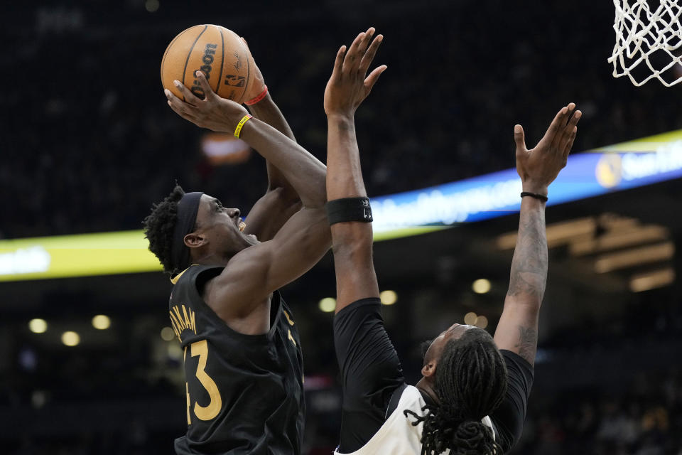 Toronto Raptors forward Pascal Siakam (43) gets fouled by Minnesota Timberwolves center Naz Reid (11) during the first half of an NBA basketball game, in Toronto, Saturday, March 18, 2023. (Frank Gunn/The Canadian Press via AP)
