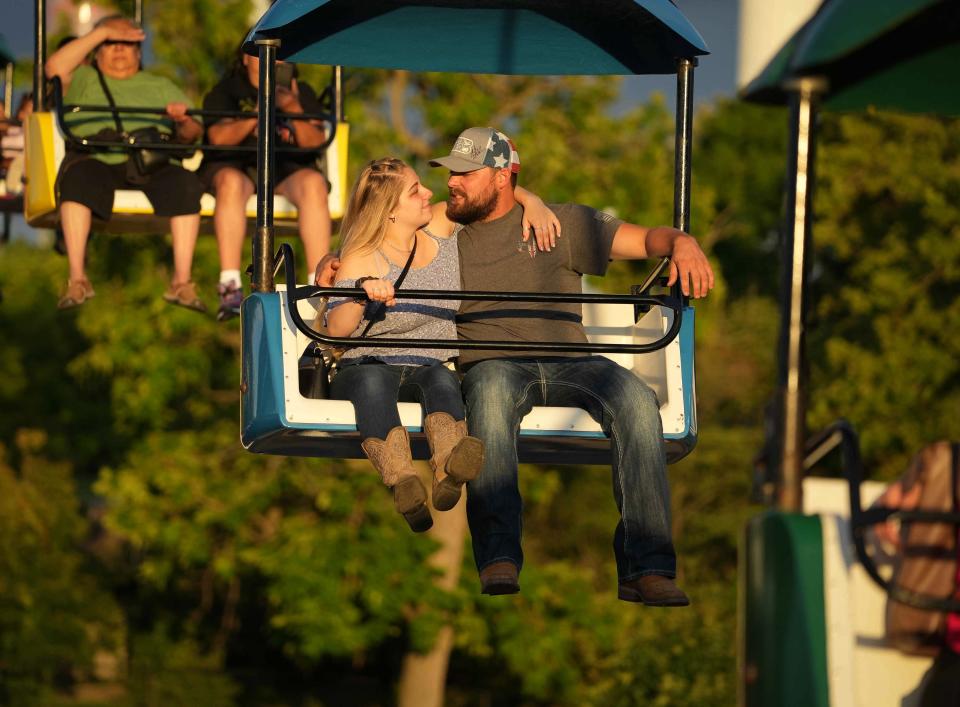 Fairgoers ride the Sky Glide over the fairgrounds during the Iowa State Fair on Saturday, Aug. 20, 2022 in Des Moines.