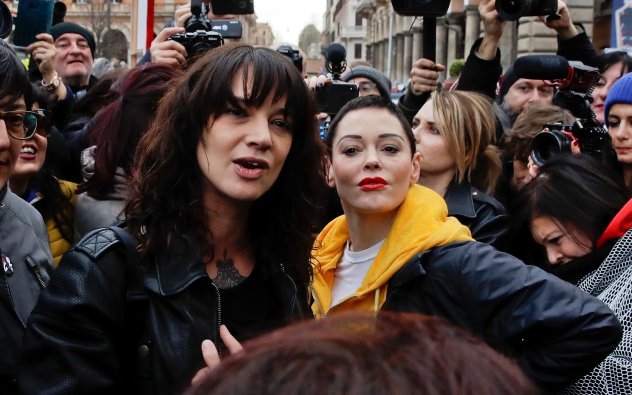Actresses Asia Argento, left, and Rose McGowan pose during a demonstration to mark the international Women's Day in Rome - AP