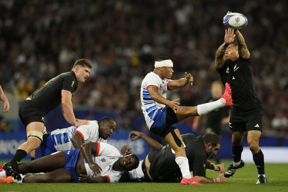 Namibia's Damian Stevens clears the ball as New Zealand's Aaron Smith tries to block during the Rugby World Cup Pool A match between New Zealand and Namibia at the Stadium de Toulouse in Toulouse, France, Friday, Sept. 15, 2023. (AP Photo/Themba Hadebe)