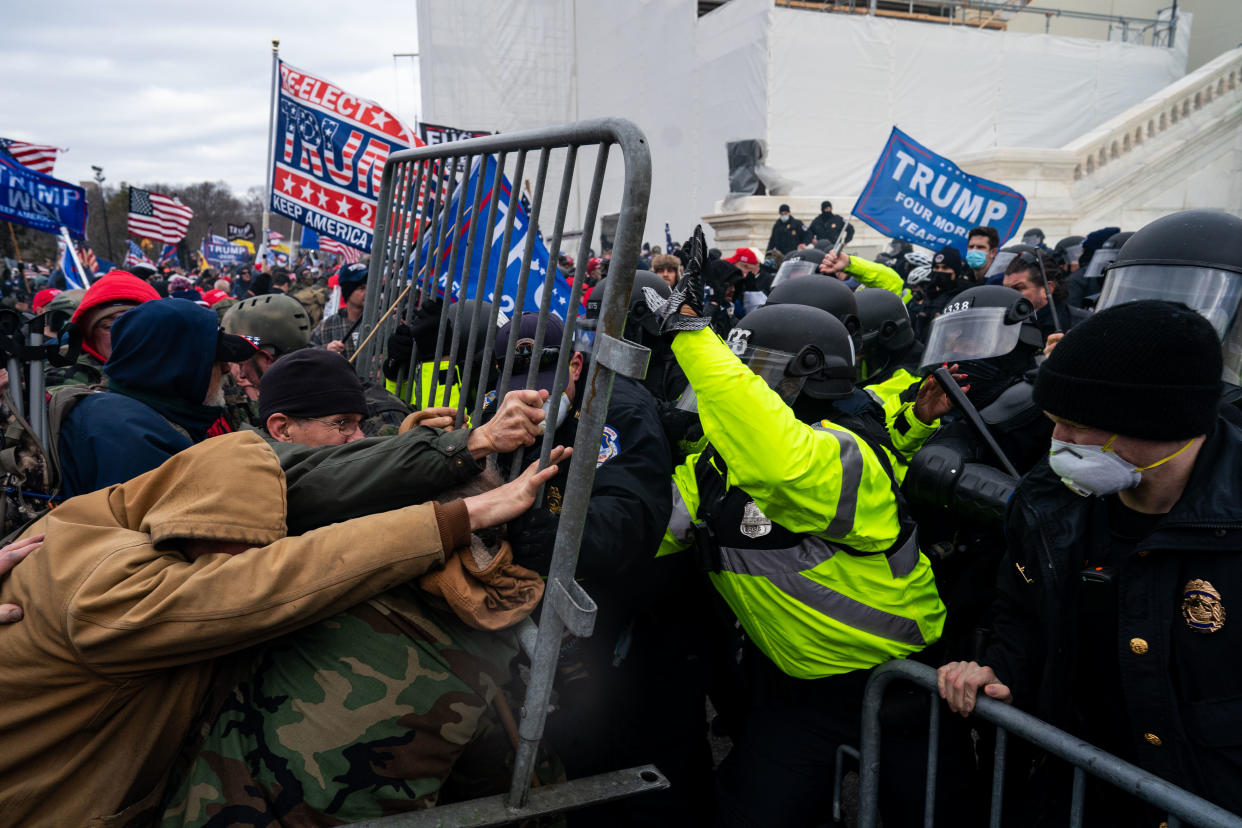 WASHINGTON, DC - JANUARY 06: Pro-Trump supporters clash with law enforcement on the west steps/inauguration stage of the U,S. Capitol as people gathered on the second day of pro-Trump events fueled by President Donald Trump's continued claims of election fraud in an to overturn the results before Congress finalizes them in a joint session of the 117th Congress on Wednesday, Jan. 6, 2021 in Washington, DC. (Kent Nishimura / Los Angeles Times via Getty Images)