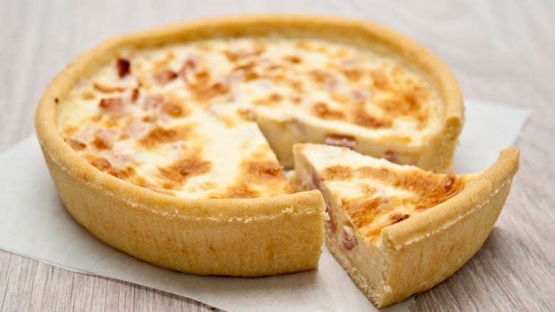 Quiche slice cut from whole 
