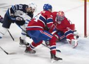 Winnipeg Jets' Mathieu Perreault (85) scores against Montreal Canadiens goaltender Carey Price as Canadiens' Joel Edmundson defends during the third period of an NHL hockey game Saturday, March 6, 2021, in Montreal. (Graham Hughes/The Canadian Press vIa AP)