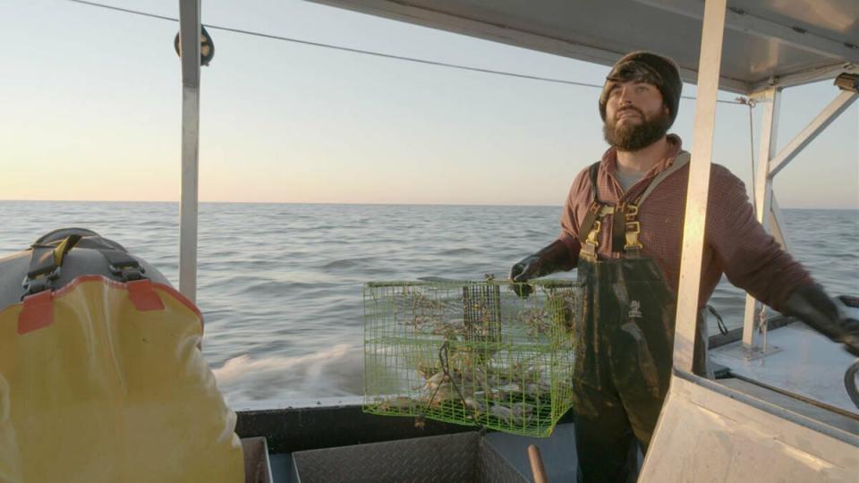 Alex Billiot, a member of the Point-au-Chien Indian Tribe, catches crabs on the waters of the Terrebonne Basin.