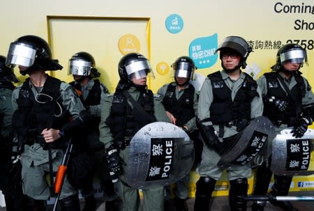 Police officers stand at Amoy Plaza shopping mall in Kowloon Bay, Hong Kong