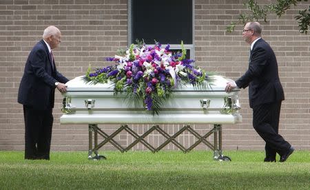 A casket carrying a member of the Stay family is unloaded prior to the funeral at the Church of Jesus Christ of Latter-day Saints in Spring, Texas July 16, 2014. REUTERS/Daniel Kramer