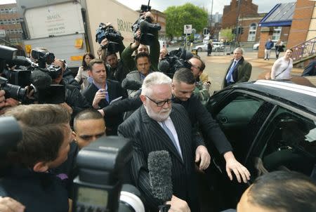 FILE PHOTO: Paul Flowers (C), the former chairman of the Co-operative Bank leaves Leeds Magistrates' Court in Northern England May 7, 2014. REUTERS/Dave Thompson