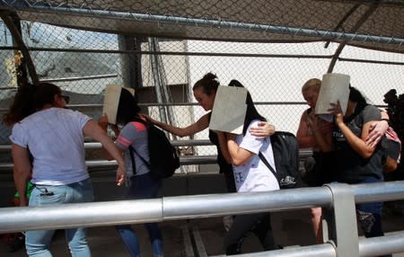 Aides of U.S. Senator Cory Booker (D-NJ) escort migrants seeking asylum towards El Paso, Texas, U.S., as seen at Paso del Norte border crossing bridge in Ciudad Juarez