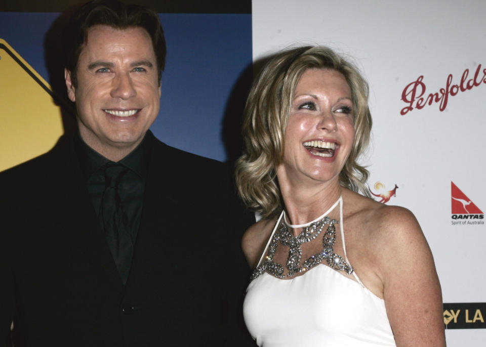 FILE - John Travolta, left, and Olivia Newton-John arrive at the The Penfolds Icon Gala Dinner in Los Angeles on Jan. 14, 2006. Travolta, who starred with Newton-John in "Grease," presented Newton-John with the "Lifetime Achievement award. Newton-John, a longtime resident of Australia whose sales topped 100 million albums, died Monday at her southern California ranch, John Easterling, her husband, wrote on Instagram and Facebook. She was 73. (AP Photo/Branimir Kvartuc, File)