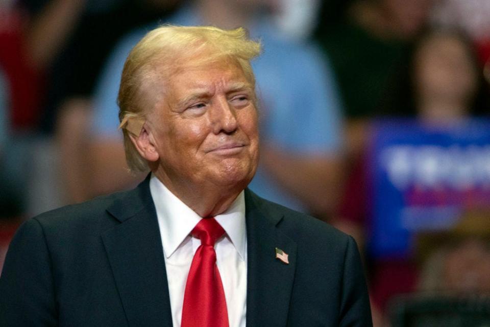 Donald Trump stands at a campaign rally