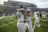 Marshall's Owen Porter, left, and Koby Cumberlander, right, celebrate after the team defeated Notre Dame in an NCAA college football game Saturday, Sept. 10, 2022, in South Bend, Ind. Marshall won 26-21. (Sholten Singer/The Herald-Dispatch via AP)