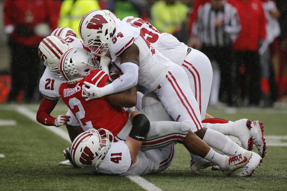 Ohio State running back J.K. Dobbins (2) is tackled by Wisconsin defenders during the first half of an NCAA college football game Saturday, Oct. 26, 2019, in Columbus, Ohio. (AP Photo/Jay LaPrete)