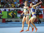 <p>Nikki Hamblin of New Zealand stops running during the race to help fellow competitor Abbey D’Agostino of USA after D’Agostino suffered a cramp. (REUTERS/Kai Pfaffenbach) </p>