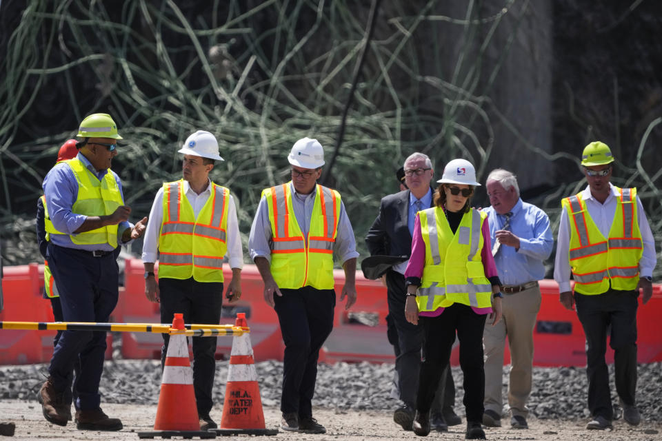 Transportation Secretary Pete Buttigieg, second left, visits the scene of a collapsed elevated section of Interstate 95, in Philadelphia, Tuesday, June 13, 2023. (AP Photo/Matt Slocum)