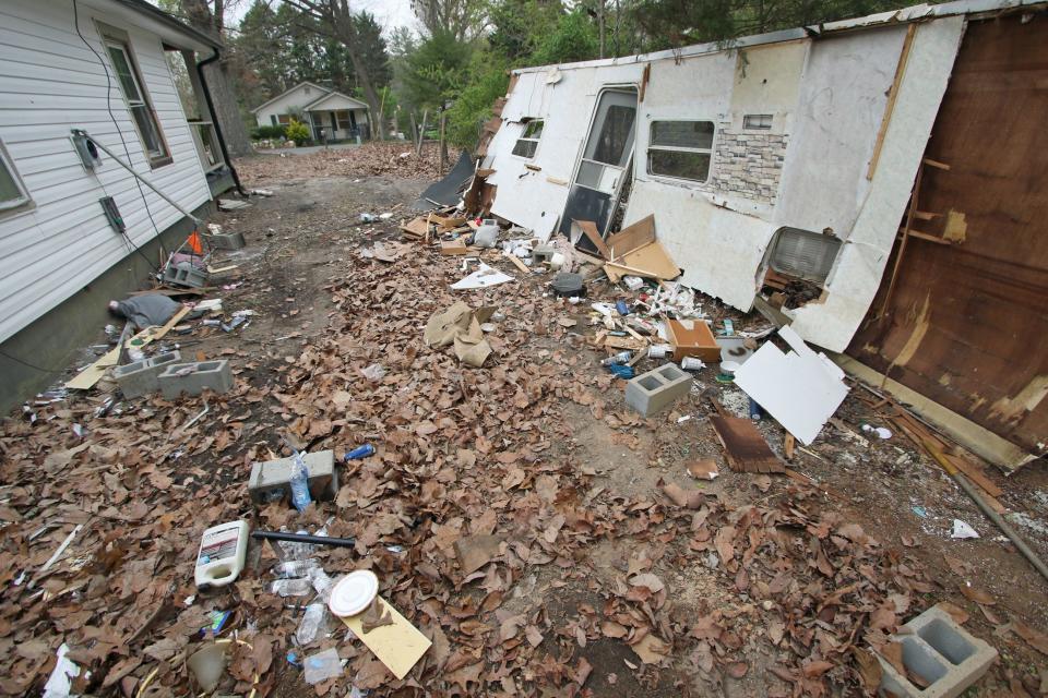 What remains of where a camper once stood next to a home on Ferrell Grove Avenue as a crew from D E P New Vision work to clean up the debris Tuesday morning, March 26, 2024.