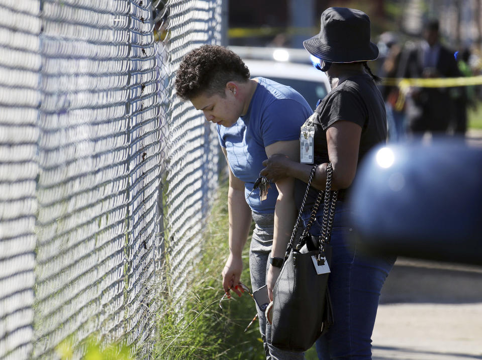 Family members of victims wait outside of a post office after a shooting, Tuesday, Oct. 12, 2021 in the Orange Mound neighborhood of Memphis, Tenn. Police investigated a shooting Tuesday at a post office in an historic neighborhood of Memphis, Tennessee, the third high-profile shooting in the region in weeks.(Patrick Lantrip/Daily Memphian via AP)