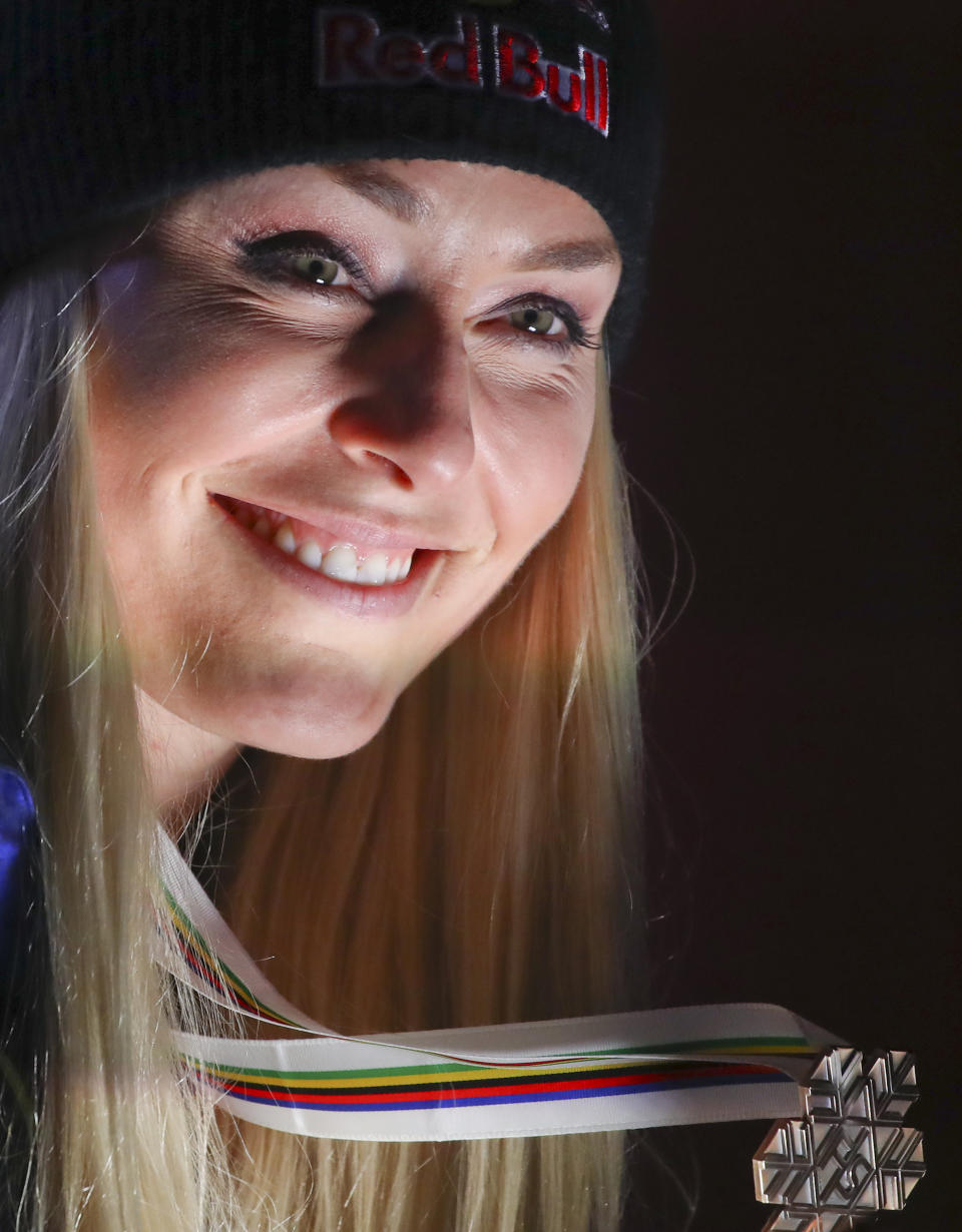 Third placed United States' Lindsey Vonn poses during the medal ceremony for the women's downhill race at the alpine ski World Championships in Are, Sweden, Sunday, Feb.10, 2019. (AP Photo/Alessandro Trovati)