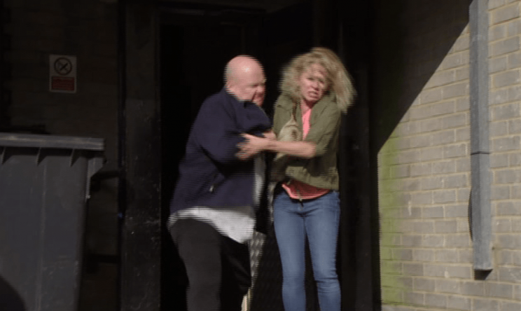 Phil throws Lisa out with the rubbish in EastEnders (BBC)