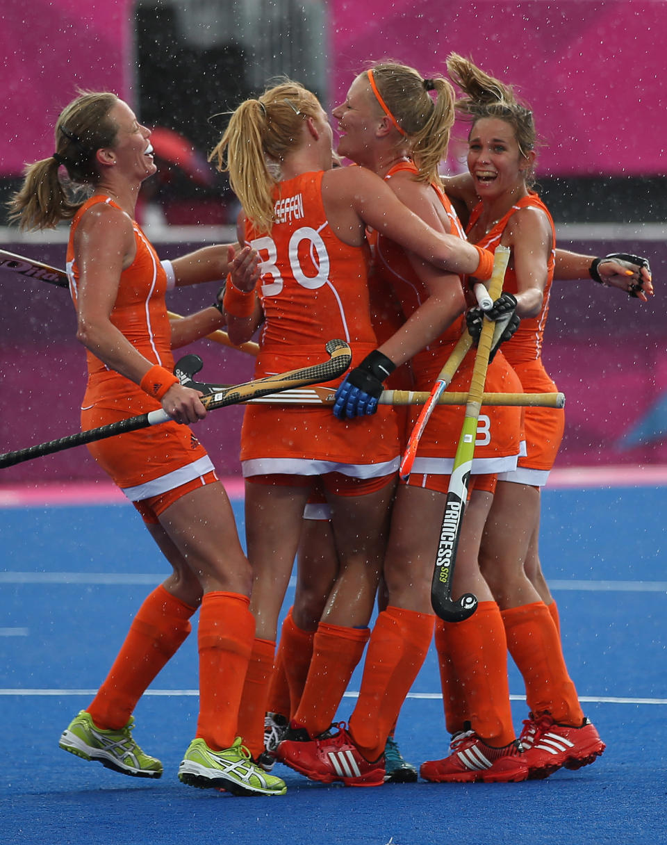 LONDON, ENGLAND - JULY 29: Caia Van Maasakker of Netherlands celebrates scoring her team's third goal with her team mates during the Women's Pool WA Match W02 between the Netherlands and Belgium at the Hockey Centre on July 29, 2012 in London, England. (Photo by Daniel Berehulak/Getty Images)