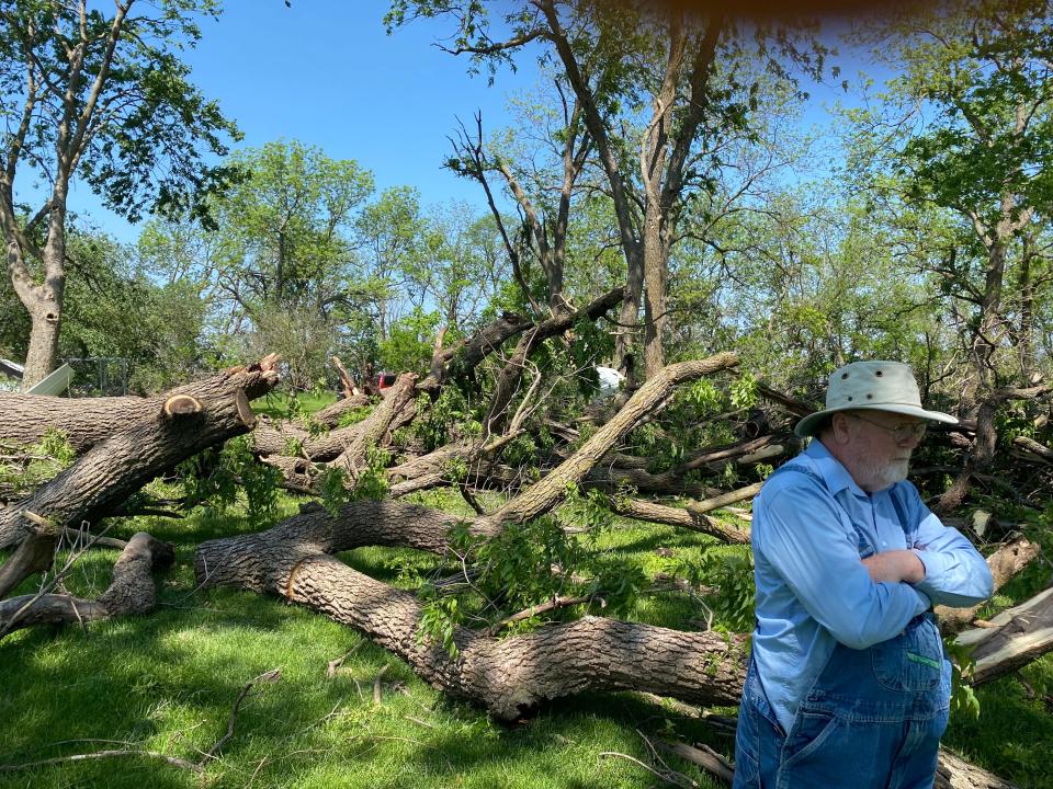 Stanley Roberts stands in front of damaged trees outside of Corning on Wednesday, May 22, 2024, a day after a powerful tornado ripped through southwest Iowa.