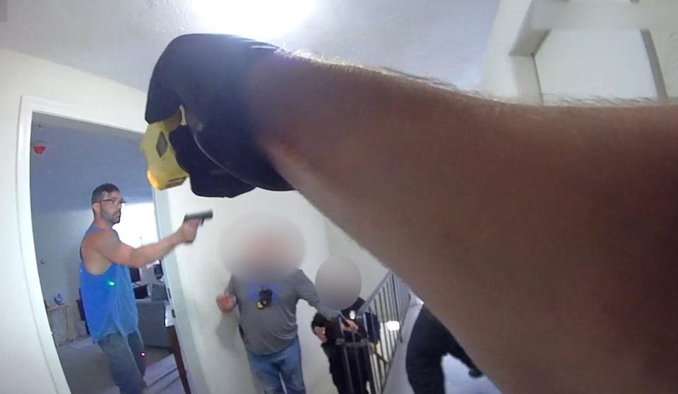 This screenshot taken from body camera footage released by the Bristol County District Attorney's Office shows the moment, according to prosecutors, that Stephen Maclean, left, pulled a handgun on Raynham police officers, leading them to fatally shoot him on Tuesday, April 30, 2024.