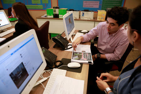 Government staff work as they monitor social media in a social media war room in Bangkok, Thailand March 8, 2019. Picture taken March 8, 2019. REUTERS/Soe Zeya Tun