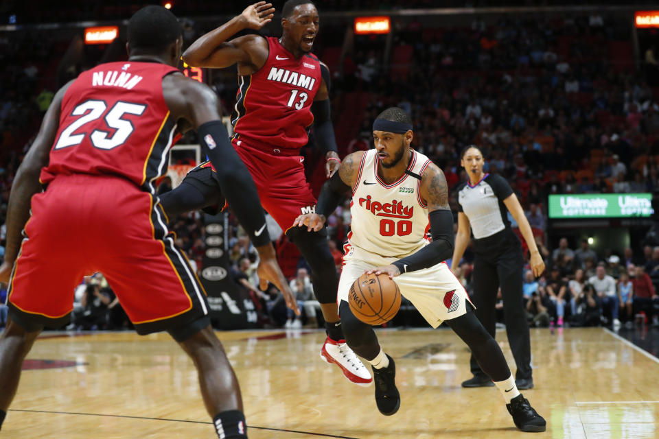 Portland Trail Blazers forward Carmelo Anthony (00) drives to the basket against Miami Heat guard Kendrick Nunn (25) and center Bam Adebayo (13) during the first half of an NBA basketball game, Sunday, Jan. 5, 2020, in Miami. (AP Photo/Wilfredo Lee)