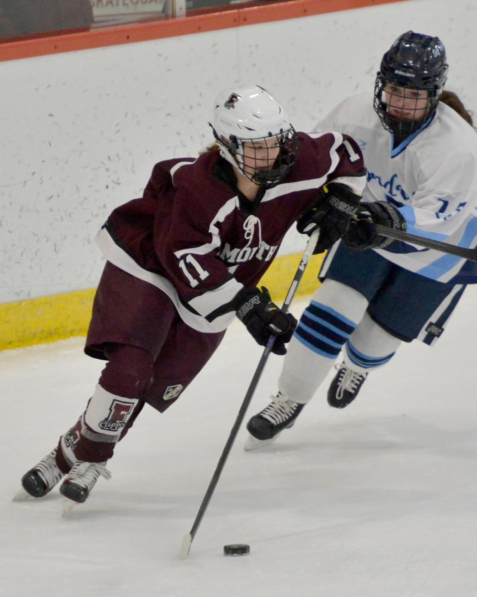 Sandwich's Casey Pestilli, right, tries to block Falmouth's Casey Roth as she skates down the ice in second period action during a Jan. 25 game in Bourne.