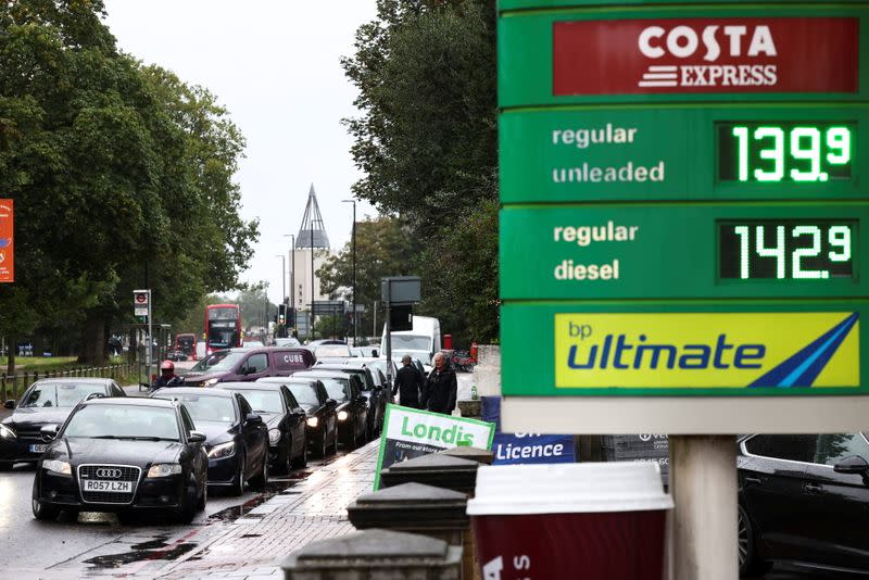 Vehicles queue to refill at a BP fuel station in London