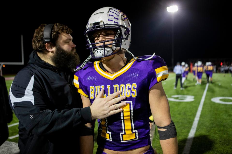 Andrew Marshall talks with an assistant coach during Bloom-Carroll's 35-12 win against Tipp City Tippecanoe in a Division III state semifinal at London High School. Marshall ran for 129 yards to help the Bulldogs reach their first state final in school history.