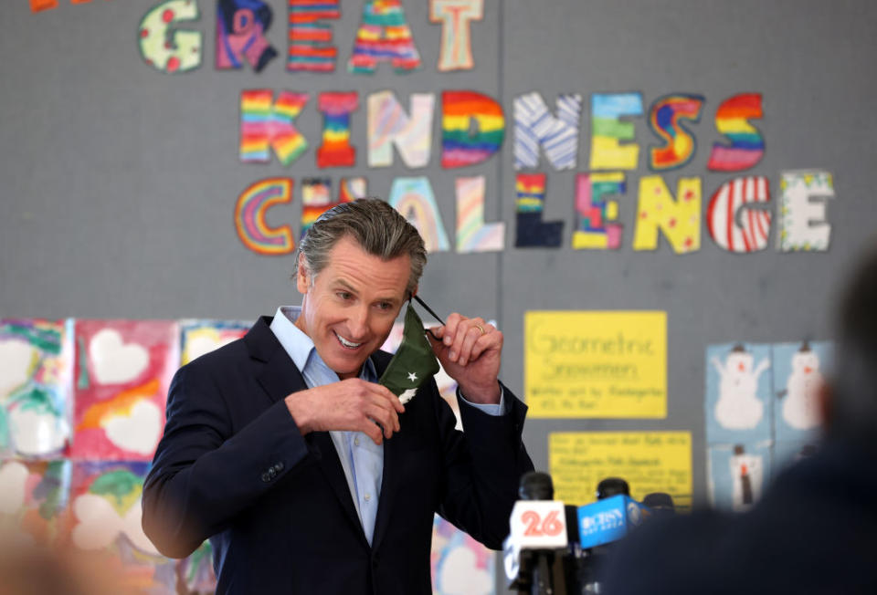 California Gov. Gavin Newsom removes his mask before speaking during a news conference after he toured the newly reopened Ruby Bridges Elementary School on March 16. Gov. Newsom travelled throughout California to highlight the state’s efforts to reopen schools as he faces the threat of recall. (Justin Sullivan / Getty Images)