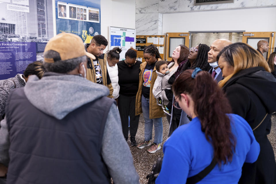 Members of Manny Ellis's family gather before the verdict is read during the trial of three Tacoma Police officers in the killing of Manny Ellis, at Pierce County Superior Court, Thursday, Dec. 21, 2023, in Tacoma, Wash. A jury cleared three Washington state police officers of all criminal charges Thursday in the 2020 death of Manuel Ellis, a Black man who was shocked, beaten and restrained face down on a Tacoma sidewalk as he pleaded for breath.(AP Photo/Maddy Grassy)