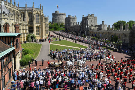 FILE PHOTO: Britain’s Prince Harry and his wife Meghan ride a horse-drawn carriage after their wedding ceremony at St George’s Chapel in Windsor Castle in Windsor, Britain, May 19, 2018. REUTERS/Toby Melville//File Photo