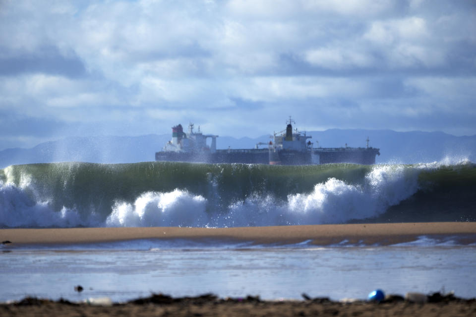 Giant waves break off the beach as shipping vessels remained moored along the coast of Southern California, seen from Seal Beach, Calif., Saturday, Dec. 30, 2023. (AP Photo/Damian Dovarganes)