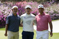 From left, Takumi Kanaya, of Japan, amateur Keita Nakajima, of Japan, and Hideki Matsuyama, of Japan, pose for a photo in front of azaleas on the 14th green during a practice round for the Masters golf tournament on Monday, April 4, 2022, in Augusta, Ga. (AP Photo/Jae C. Hong)