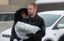 People bring flowers at the scene of a fatal shooting at the Quebec Islamic Cultural Centre in Quebec City. REUTERS/Mathieu Belanger