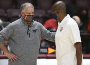 Virginia Tech head coach Mike Young, left,and Radford head coach Mike Jones talk at the conclusion of an NCAA college basketball game, Wednesday Nov. 25, 2020, in Blacksburg Va. (Matt Gentry/The Roanoke Times via AP)