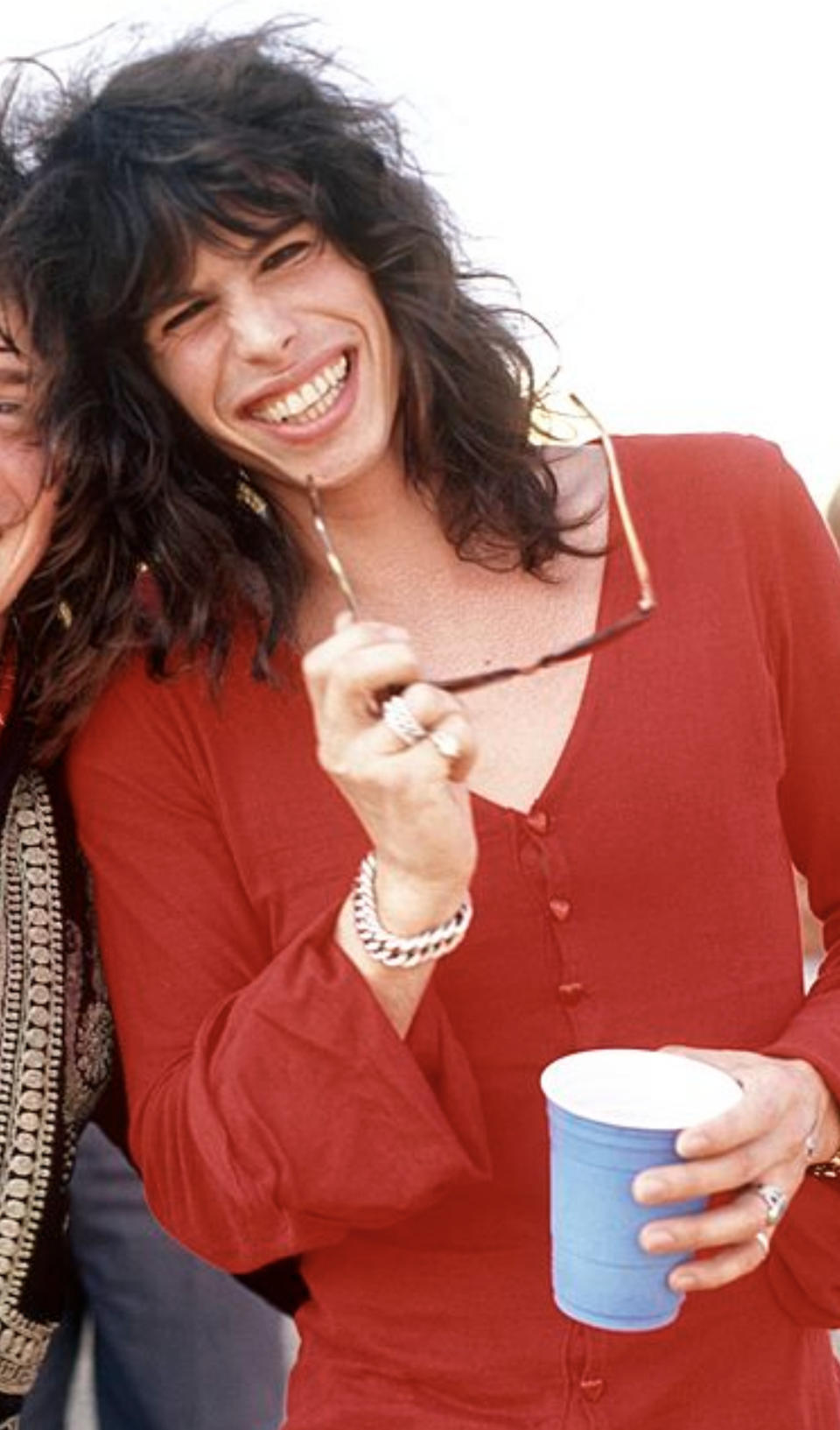 Tyler happily posing for a picture while on tour with Aerosmith in 1976