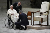 Pope Francis prepares to leave on a wheelchair at the end of his weekly general audience in the Paul VI Hall at the Vatican, Wednesday, Dec. 28, 2022. (AP Photo/Alessandra Tarantino)