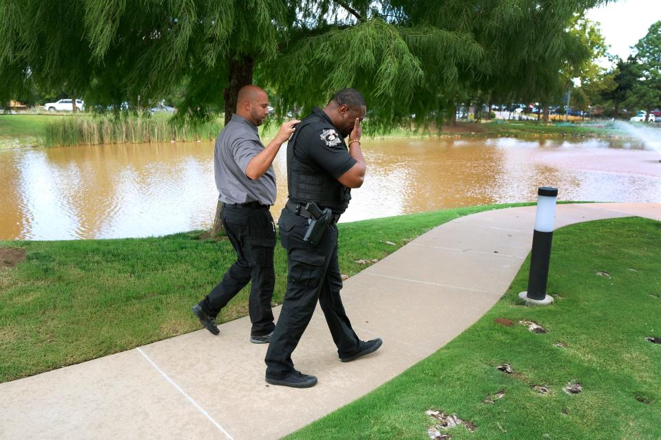 Oklahoma County Sheriff Tommie Johnson III is consoled Monday, Aug. 20, 2022, as law enforcement officers gather at OU Medical trauma center after two deputies were shot.