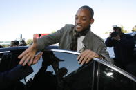 Actor Will Smith is greeted by an unidentified airport staff fan as he steps into a car upon his arrival at Ciampino airport in Rome, Friday, Nov. 17, 2006. Smith is in Rome to attend the expected wedding of actors Tom Cruise and Katie Holmes, likely to take place at a medieval lakeside town Bracciano, outside Rome, on Saturday. (AP Photo/Alessandra Tarantino)